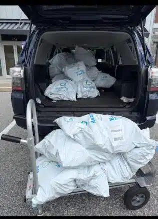 Collected sneakers fill Maura Frignito’s vehicle, ready for recycling through her hospital-led sustainability effort.