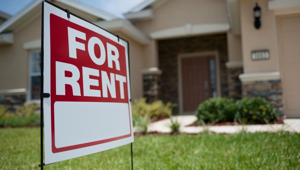 House with for rent sign out front.