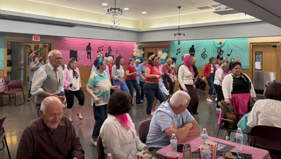 Seniors dancing and socializing at a 1950s-themed anniversary celebration at the West Chester Area Senior Center.