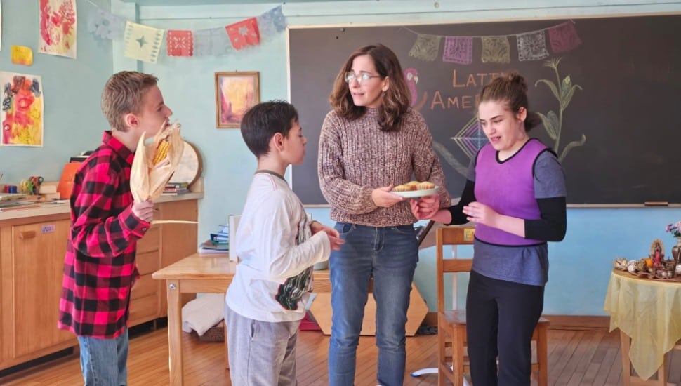 Students at the Camphill School work with a teacher presenting food items unique to Latin America's cuisine.