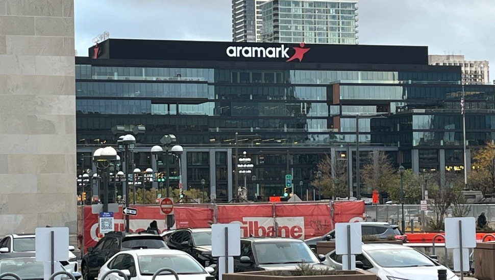 Exterior view of Aramark's corporate headquarters building in Philadelphia with the Aramark logo prominently displayed on the facade.