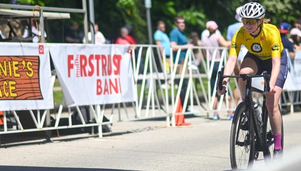 Bike rider crosses the finish line.