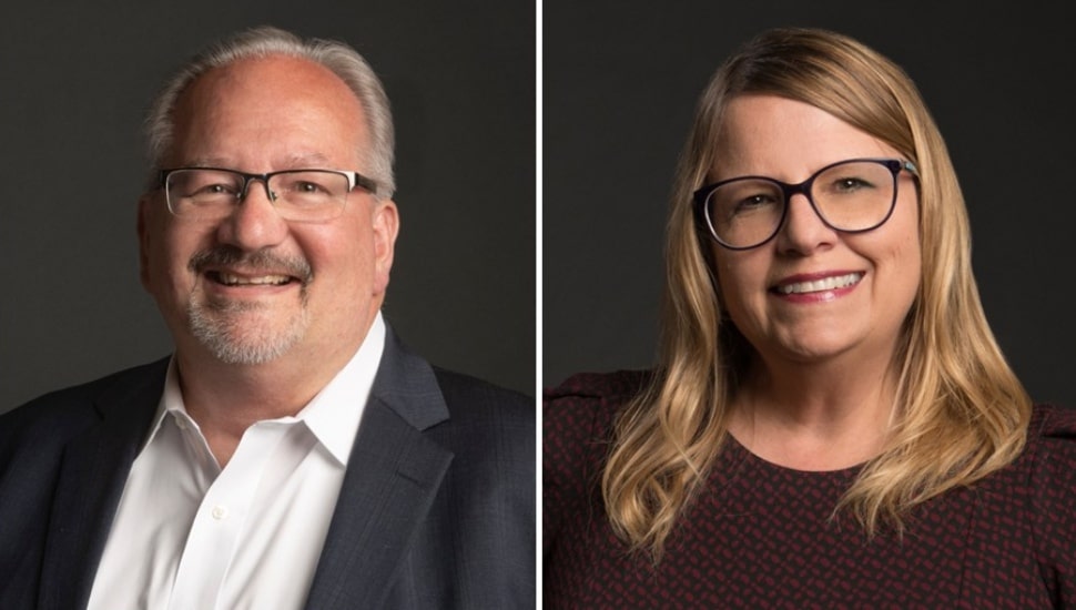 Headshot of middle-aged male and female business executives.