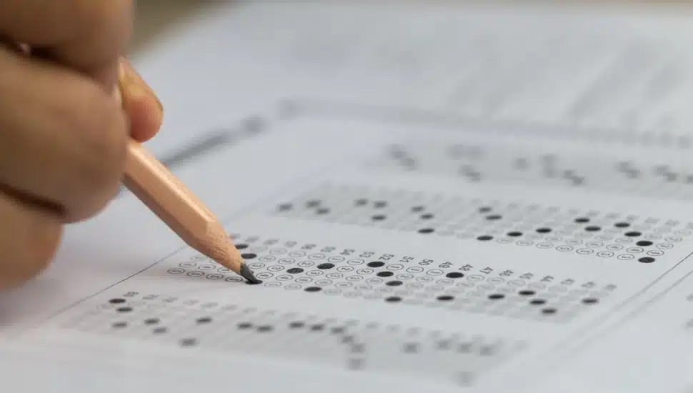 A student filling in a standardized testing sheet.