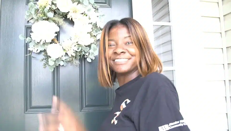 Tiffany Starkes of Thistle Hills at a front door.