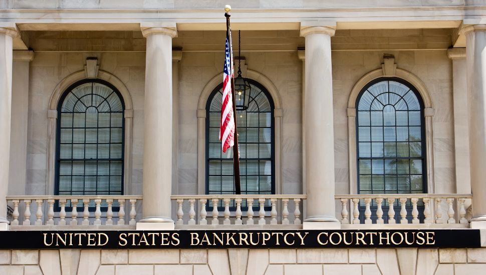 Exterior of US bankruptcy court with windows and American flag.