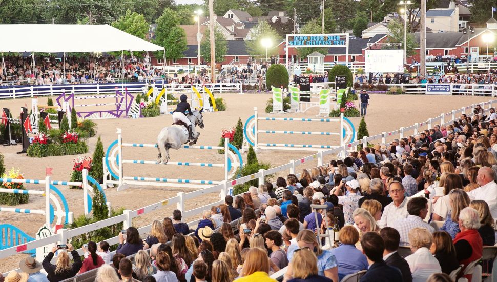 People watching horse jumping events at Devon Horse Show.