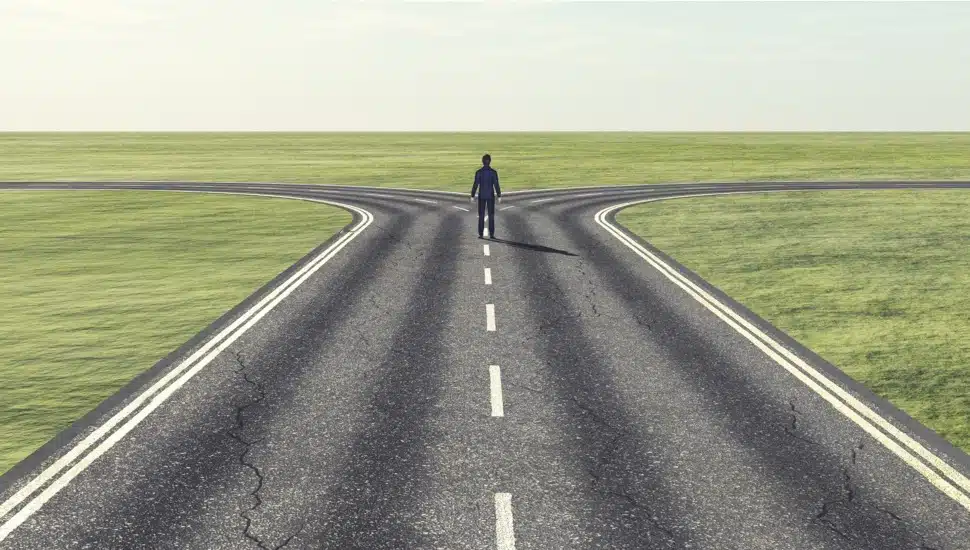 Businessman has to choose which path.