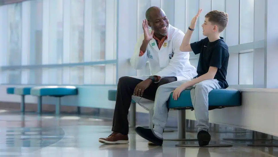 Doctor high-fives child.