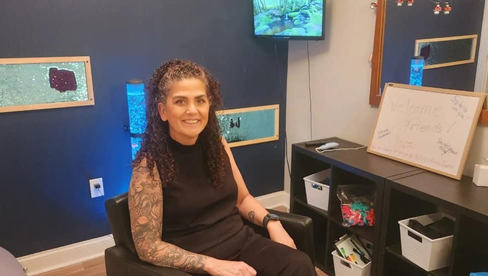 Maureen Helms sitting at office desk.