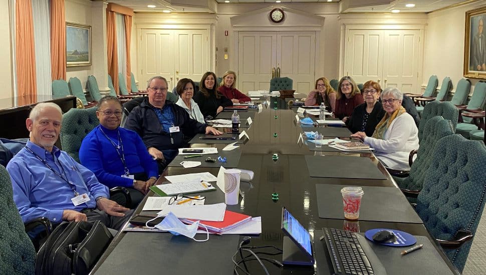 Members of the Chester County Hospital Patient and Family Advisory Committee seated around a conference table during a monthly meeting.