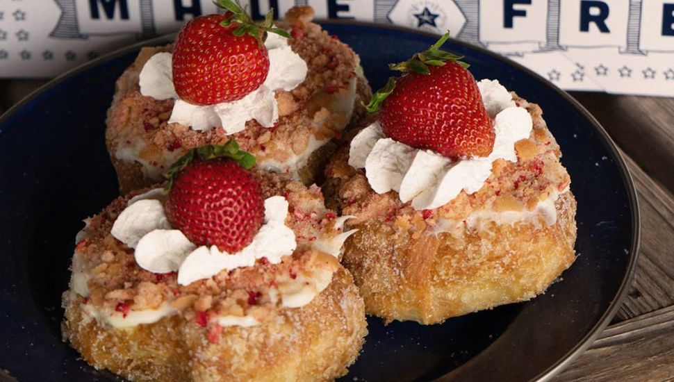 3 donuts on plate with strawberries on top from Parlor Doughnuts.