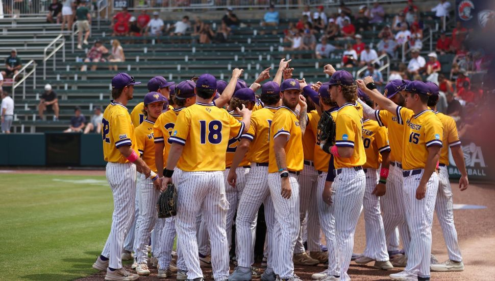 WCU baseball team together on the field.