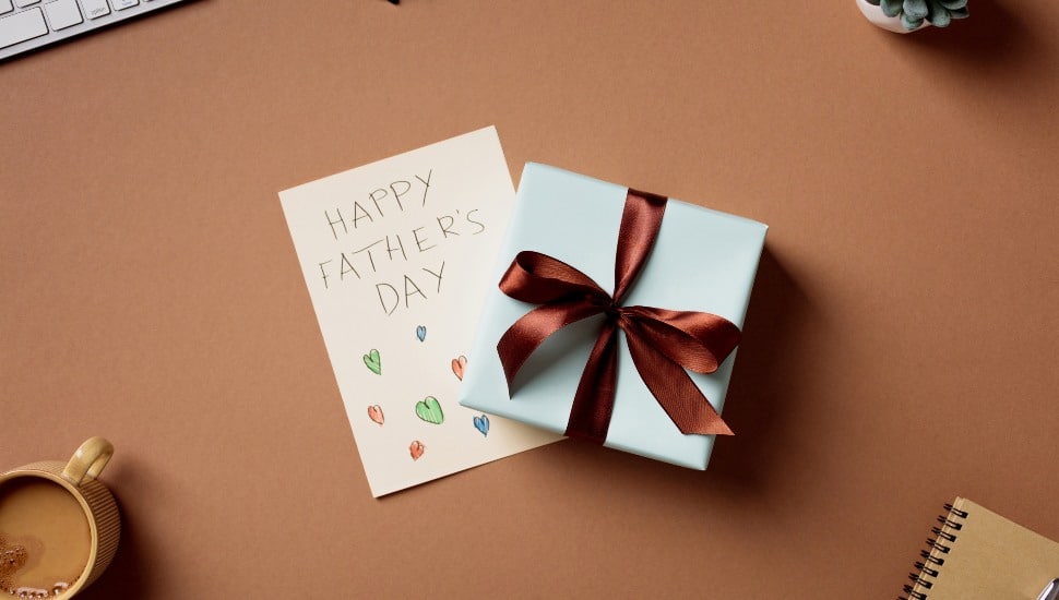 Father's Day gift and greeting card on office table.