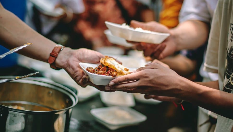 Volunteers feeding people in a shelter.