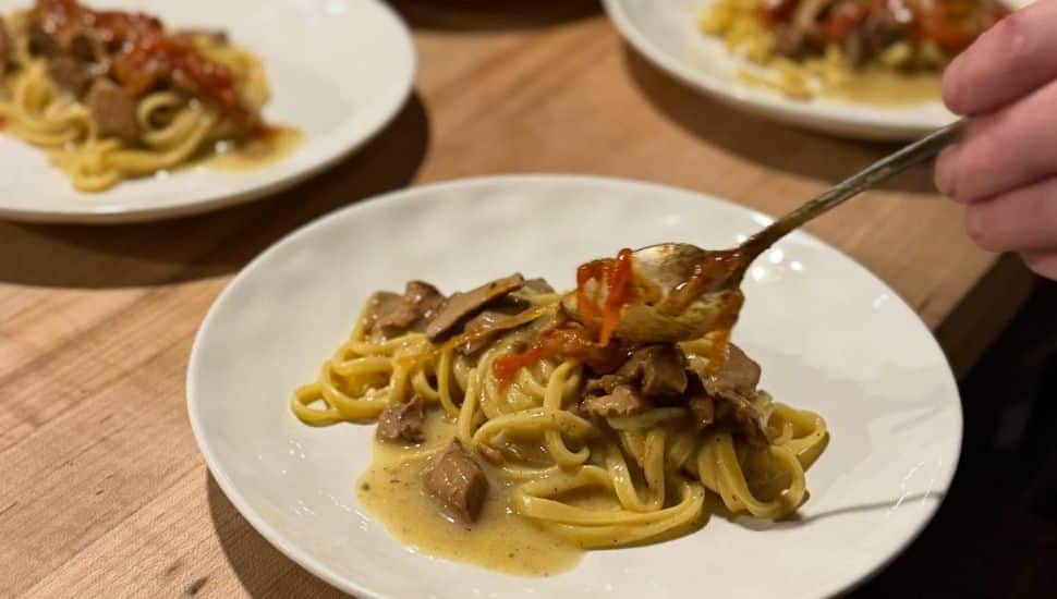Ground Provisions pasta dish on white plate.